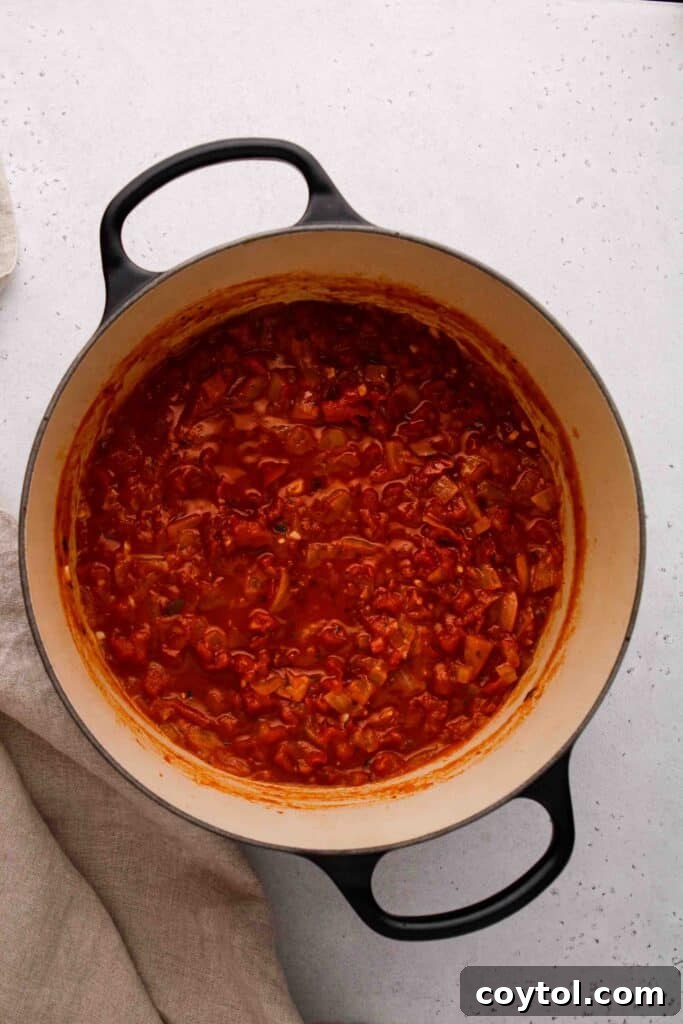 Speedy Homemade Marinara in 30 Minutes 8 A close-up of quick marinara sauce simmering in a pot.