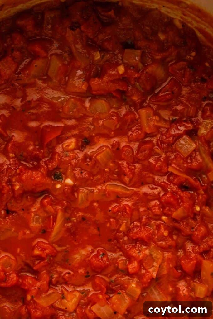 Speedy Homemade Marinara in 30 Minutes 10 Marinara sauce simmering in a pot before being blended for a smoother consistency.