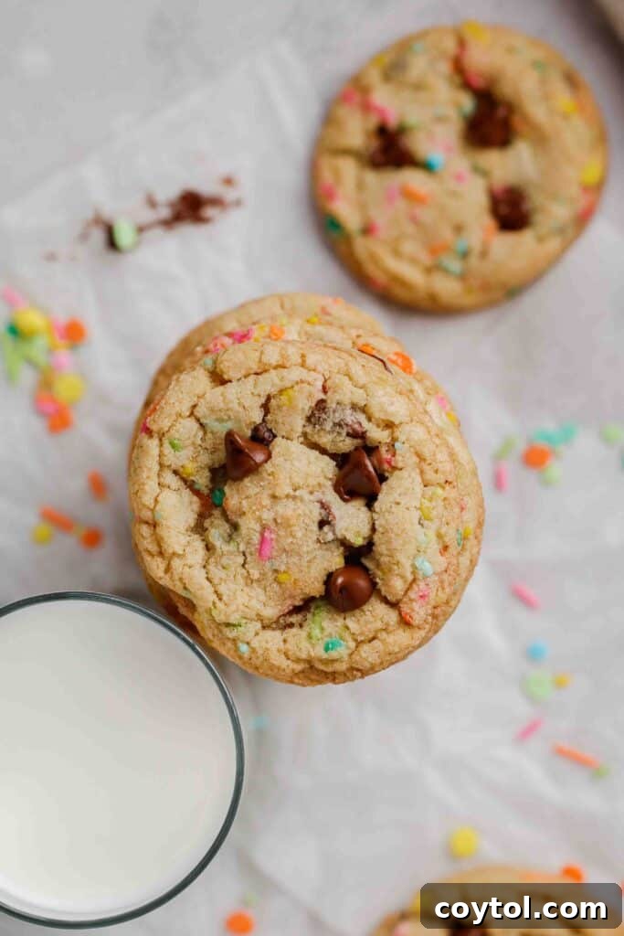 Overhead shot of a platter of festive spring chocolate chip cookies, adorned with colorful sprinkles.