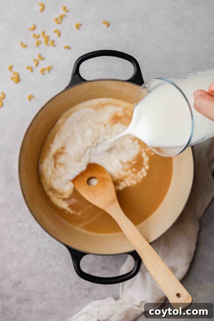 Unforgettable Stovetop Mac and Cheese 8 Incorporating milk and heavy cream into the flour and butter mixture