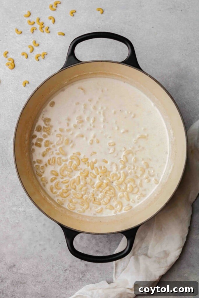 Unforgettable Stovetop Mac and Cheese 10 Pasta cooking in the creamy sauce