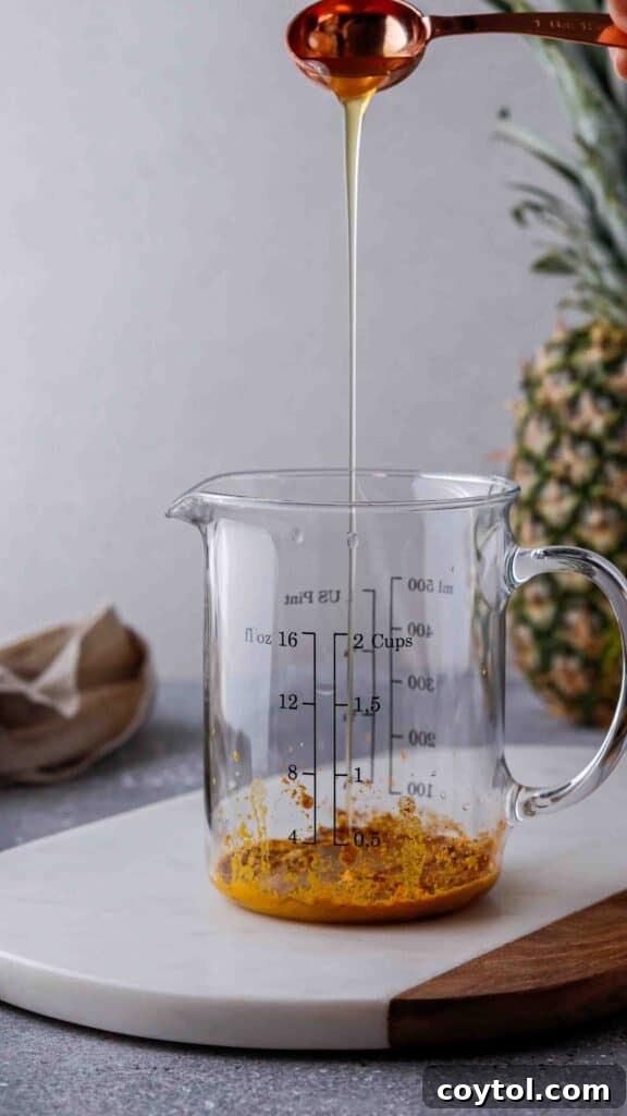 Adding ginger syrup to spices for the Iced Golden Ginger Drink