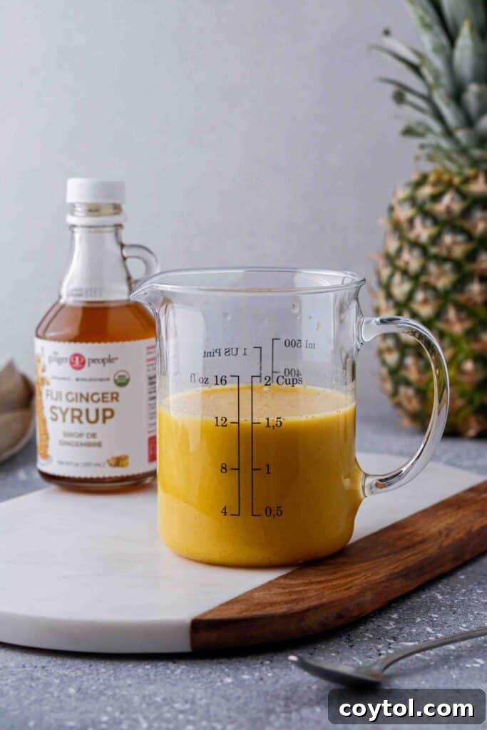 The Iced Golden Ginger drink mixture in a measuring cup