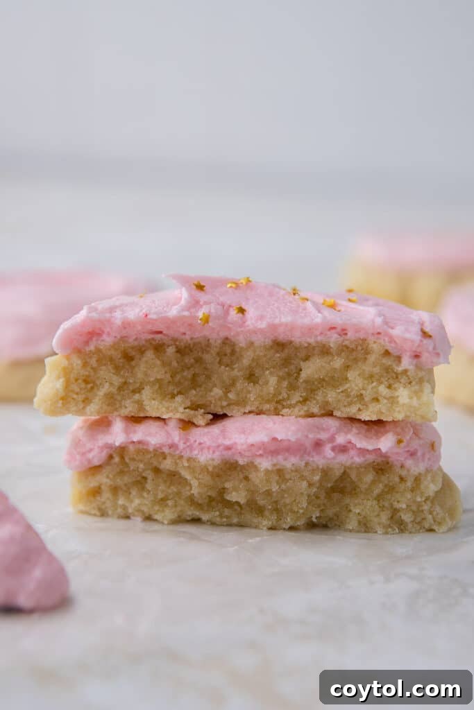 Crumbl Style Chilled Sugar Cookies 13 A Crumbl sugar cookie broken in half, revealing its soft interior
