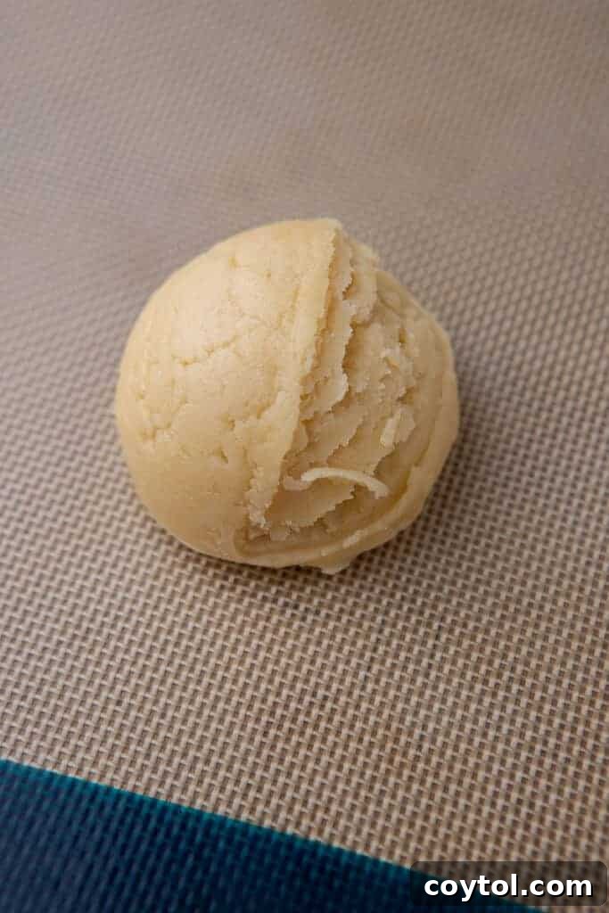 Crumbl Style Chilled Sugar Cookies 8 Portioned sugar cookie dough balls on a baking sheet