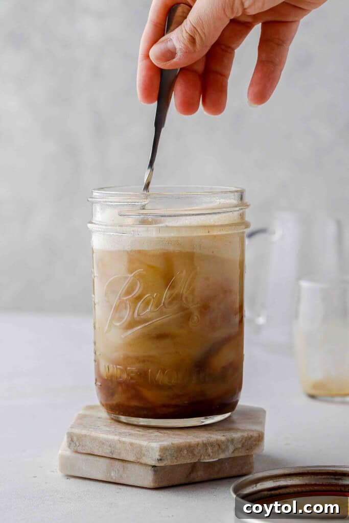 Brown Sugar Oat Espresso Velvet 11 Stirring the finished shaken oat milk espresso