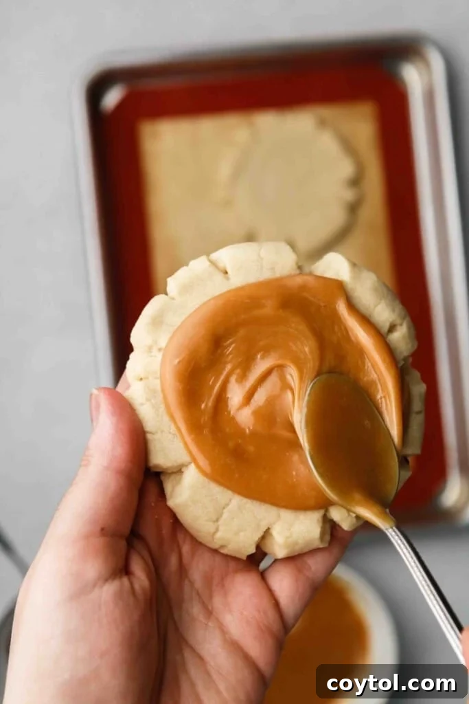 Spreading caramel on sugar cookie