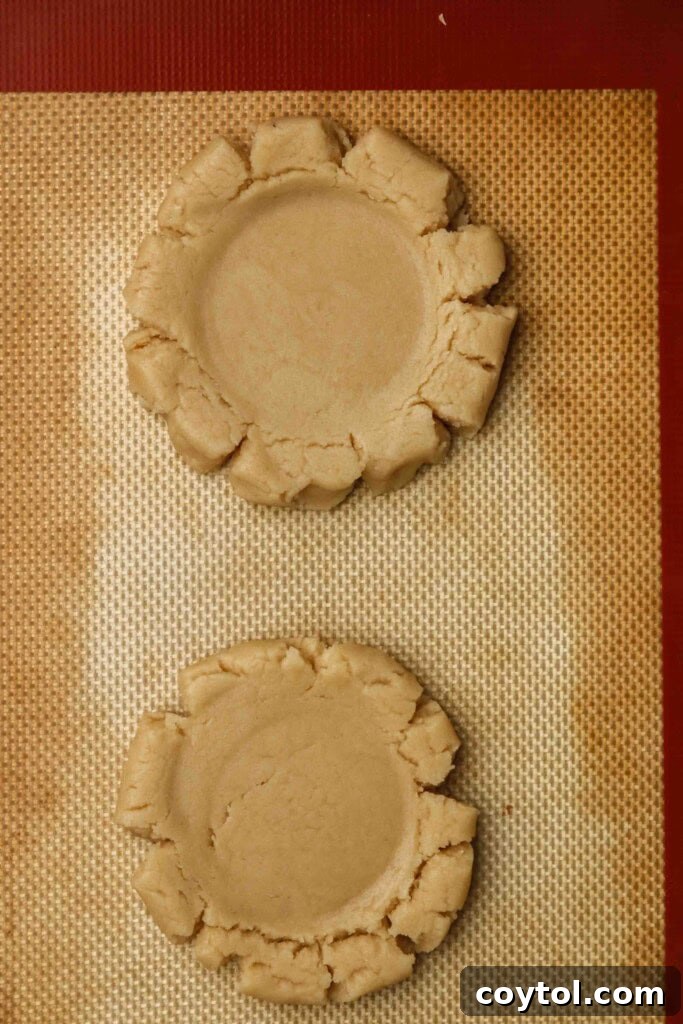 Raw sugar cookies on a baking sheet