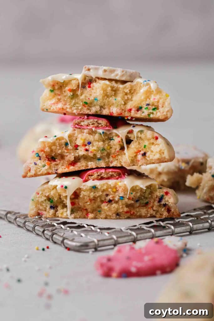 Pillowy Soft Crumbl Circus Animal Cookies 2 Close up of sugar cookies split in half, showing their soft, chewy texture.