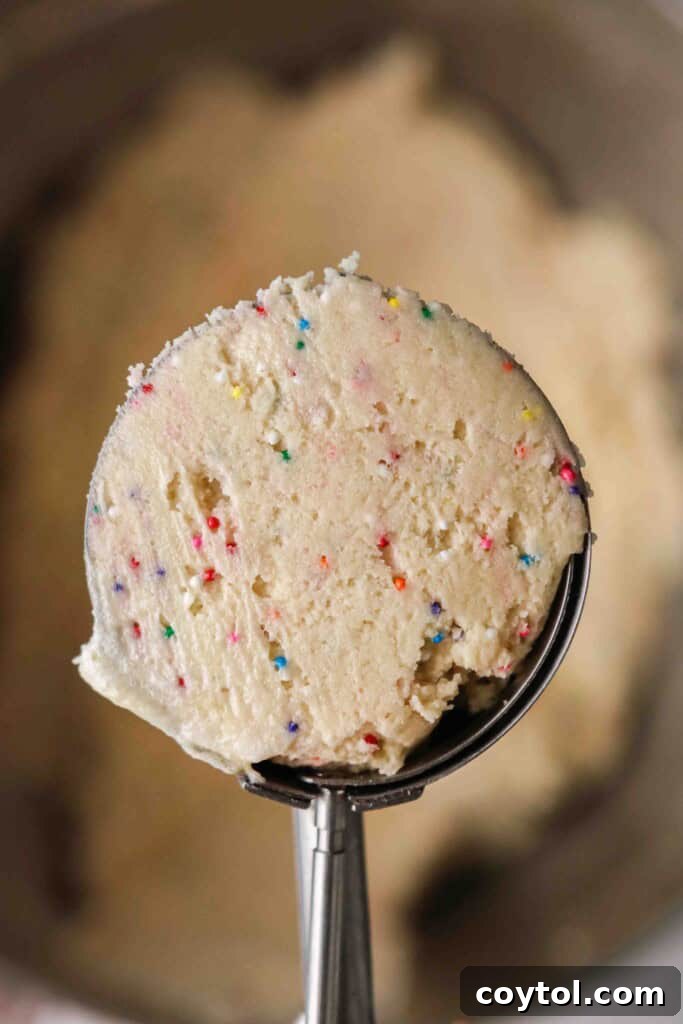 Pillowy Soft Crumbl Circus Animal Cookies 9 Cookie dough scooped into a large cookie scoop, ready for baking.