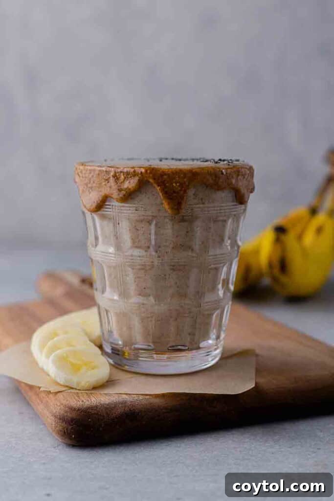 Golden Goodness Almond Banana Date Smoothie 2 A refreshing almond banana date smoothie in a glass, ready to be enjoyed.