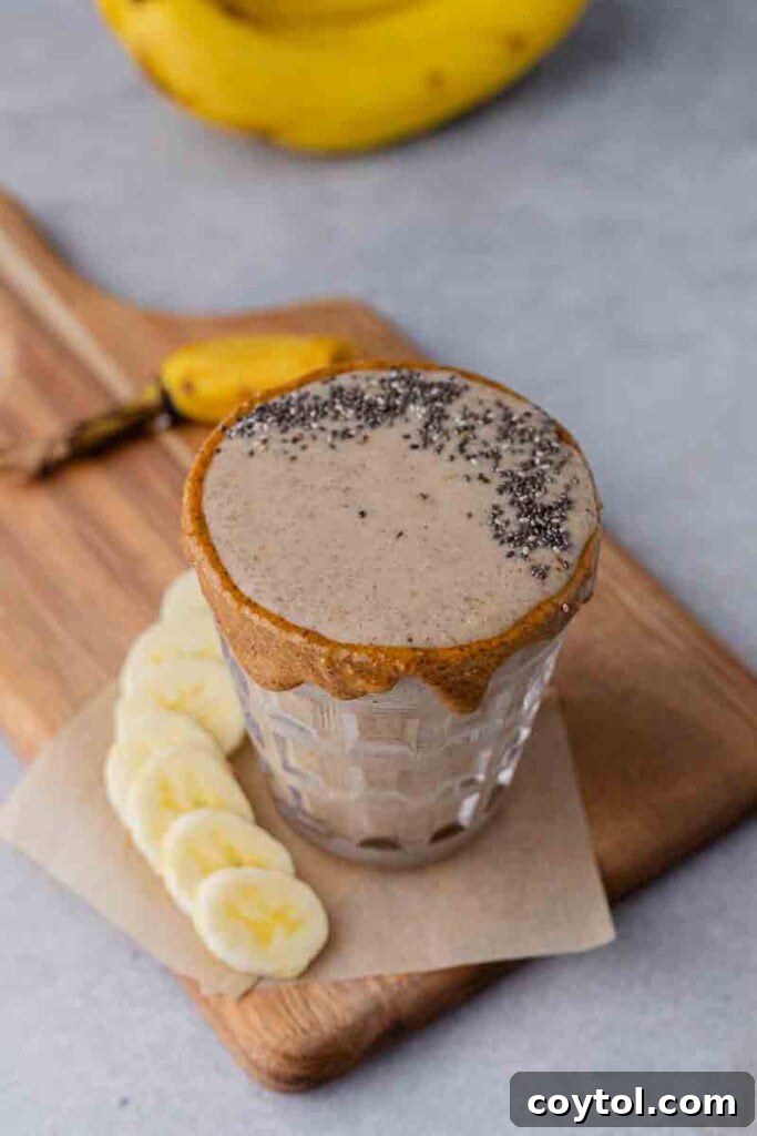Golden Goodness Almond Banana Date Smoothie 6 A refreshing banana date smoothie served in a glass with a straw.