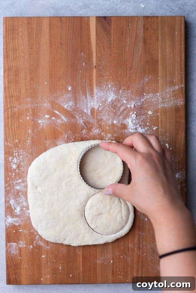 Hand cutting biscuits with a round cutter