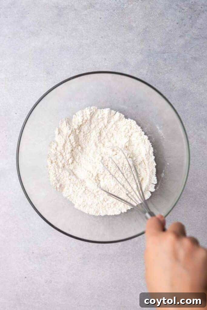 Hand whisking dry ingredients for biscuits
