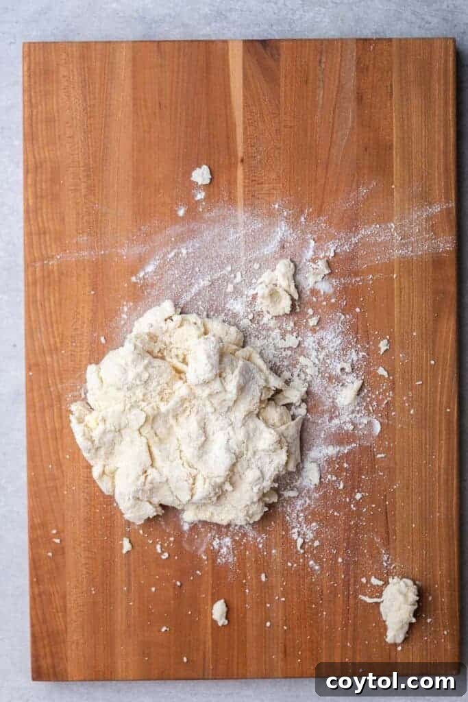 Shaggy biscuit dough in a bowl after buttermilk is added
