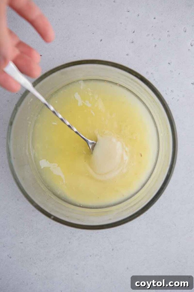 Freshly squeezed lemon juice collected in a bowl, ready for the creamy lemonade recipe