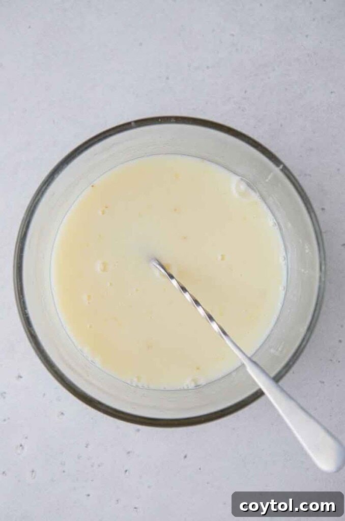 Mixing fresh lemon juice with sweetened condensed milk and granulated sugar to create a creamy base