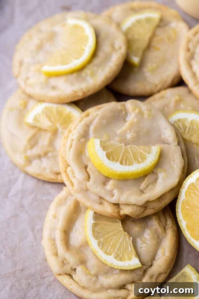 Effortless Bakery-Style Lemon Glaze Cookies 2 Lemon cookie on a baking sheet, glistening with glaze