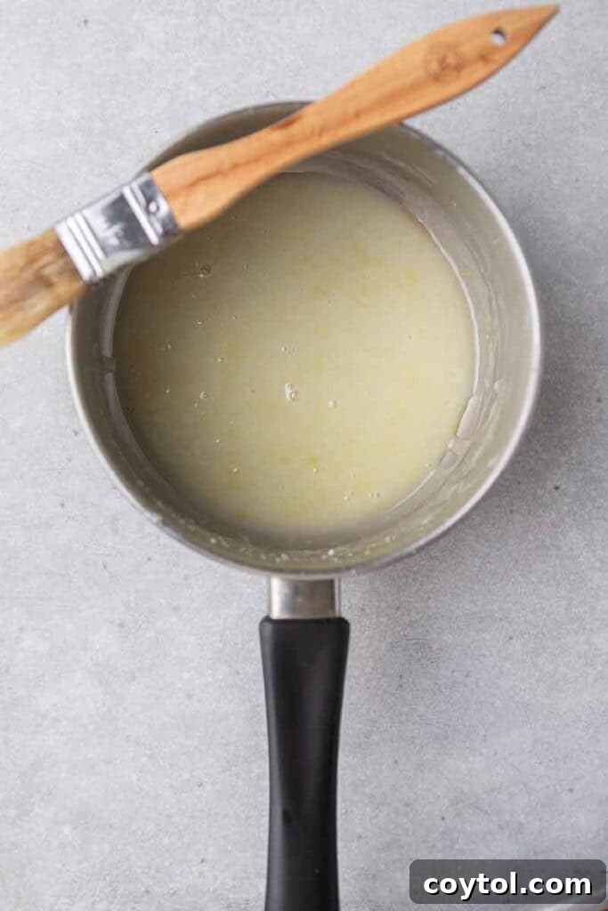 Effortless Bakery-Style Lemon Glaze Cookies 11 Lemon butter sauce simmering in a saucepan