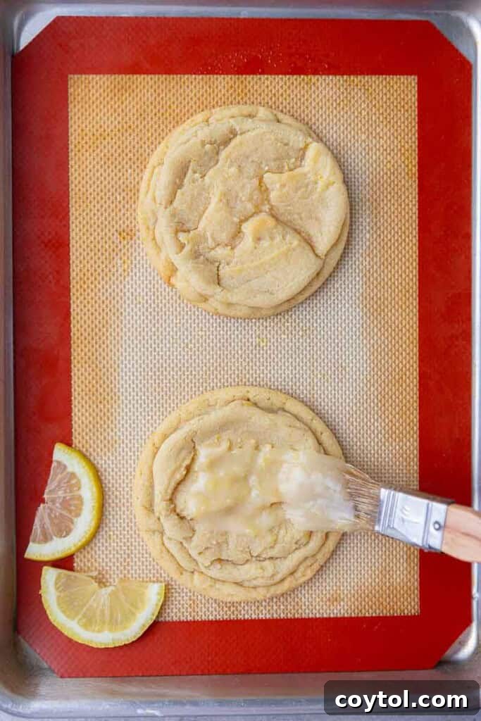 Effortless Bakery-Style Lemon Glaze Cookies 12 Glazing lemon cookies with a pastry brush