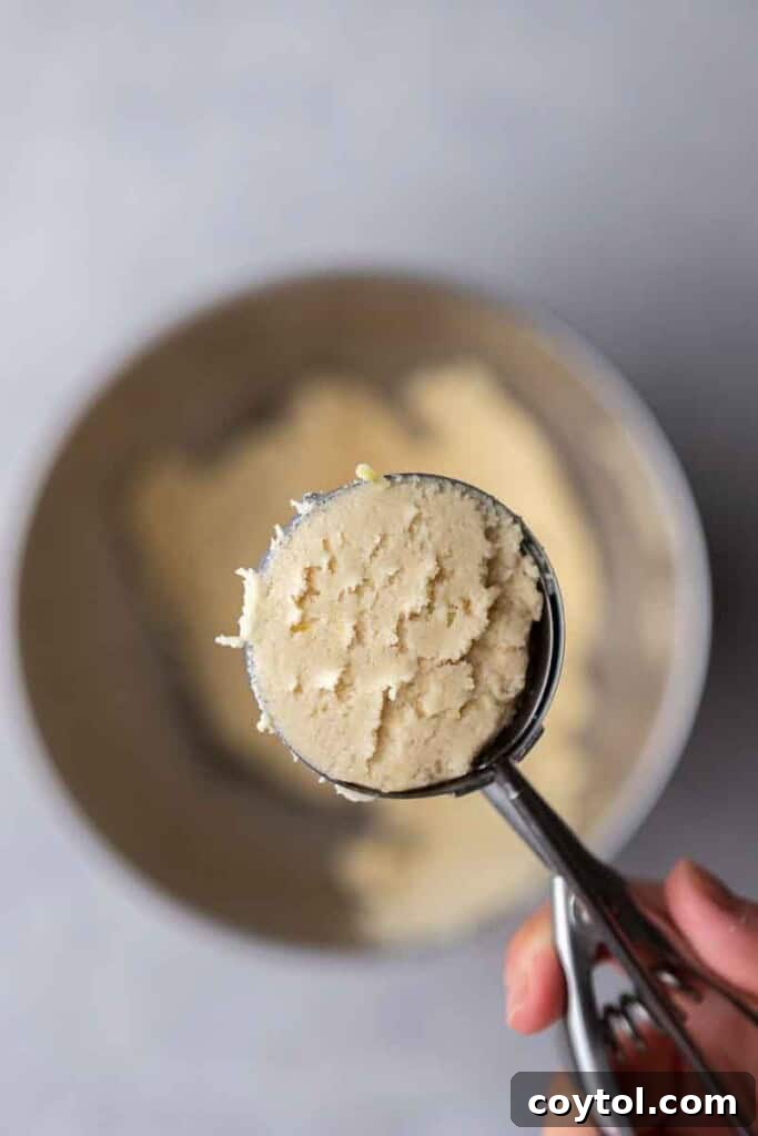 Effortless Bakery-Style Lemon Glaze Cookies 7 Lemon cookie dough in a cookie scoop