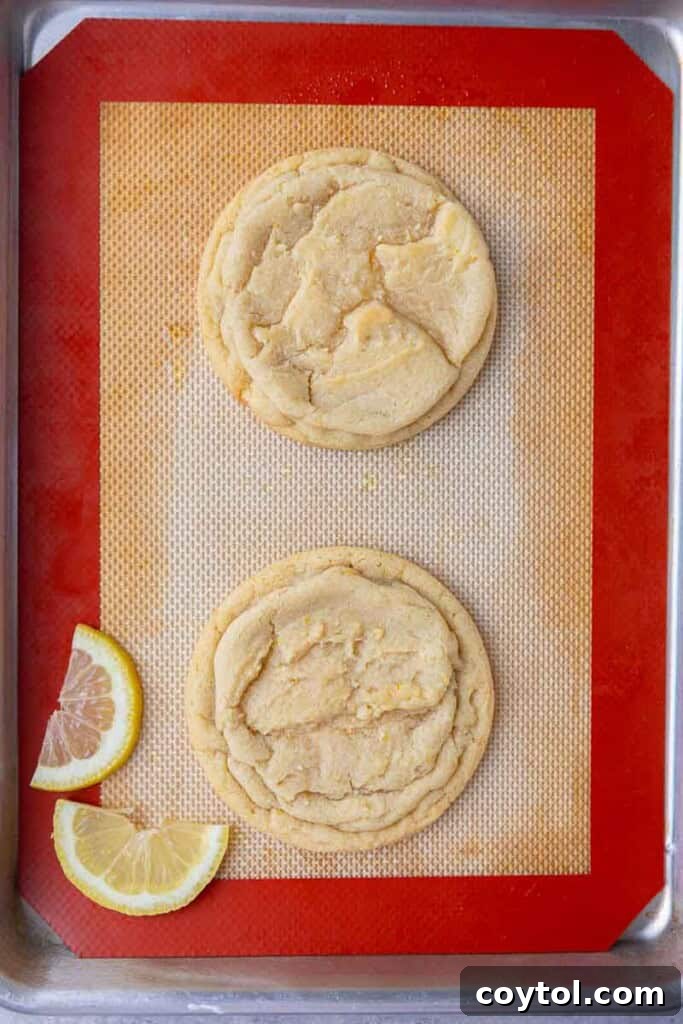 Effortless Bakery-Style Lemon Glaze Cookies 9 Freshly baked CRUMBL lemon glaze cookies on a cooling rack