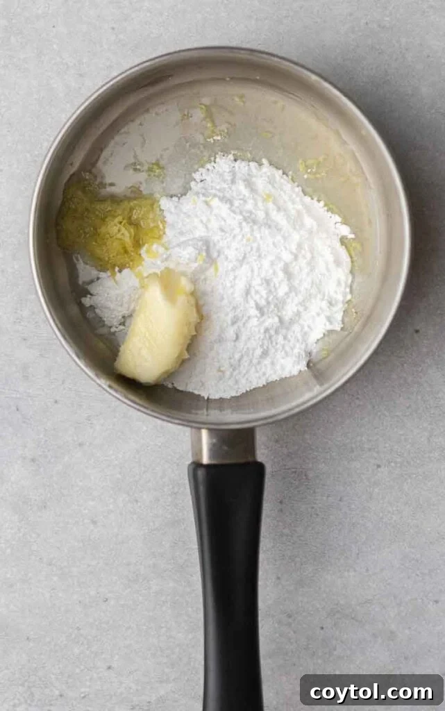 Effortless Bakery-Style Lemon Glaze Cookies 10 Lemon butter sauce in a saucepan being stirred