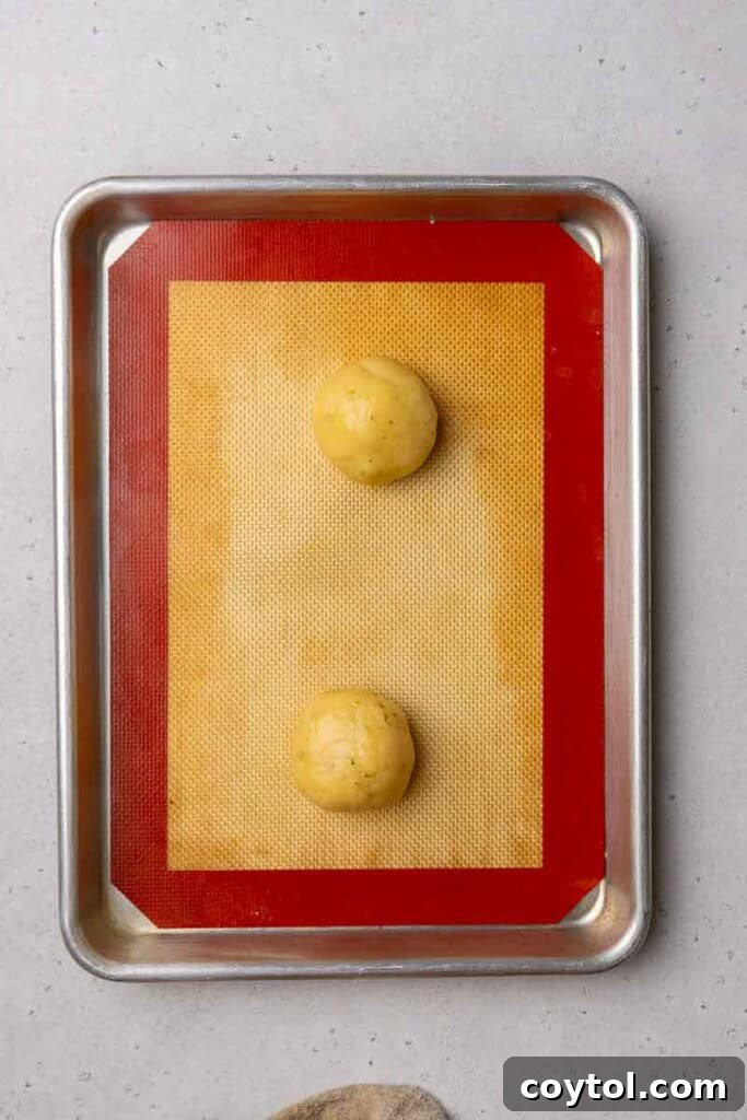 Zesty Island Chill Coconut Lime Cookies 8 Portioned cookie dough balls on a baking sheet.