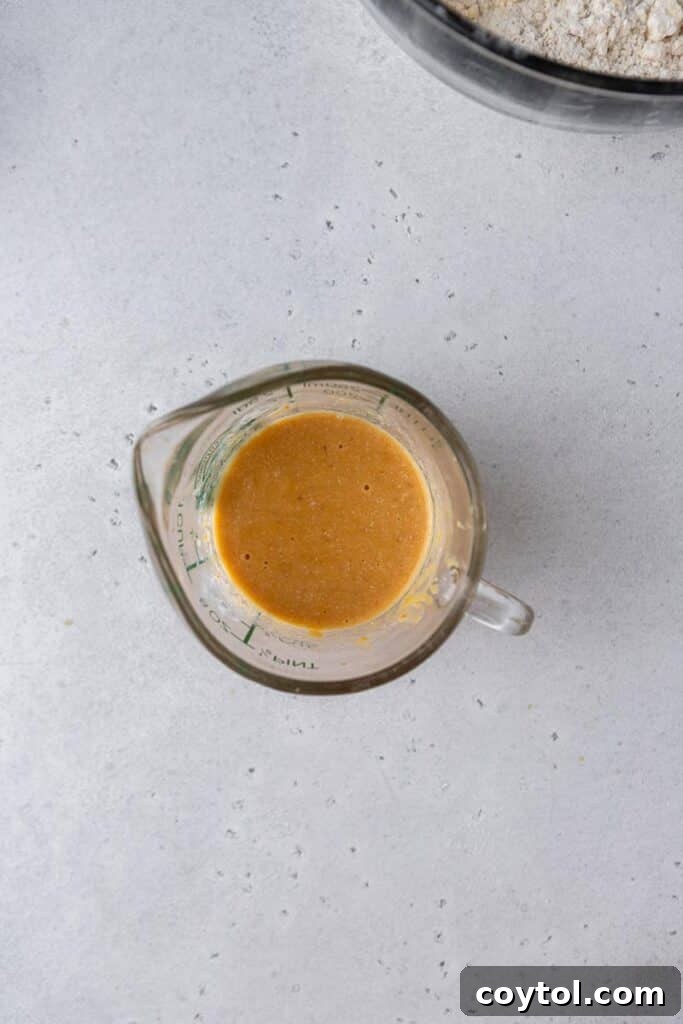 Adding pumpkin puree and buttermilk to dry ingredients