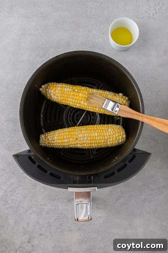 Brushing corn with oil
