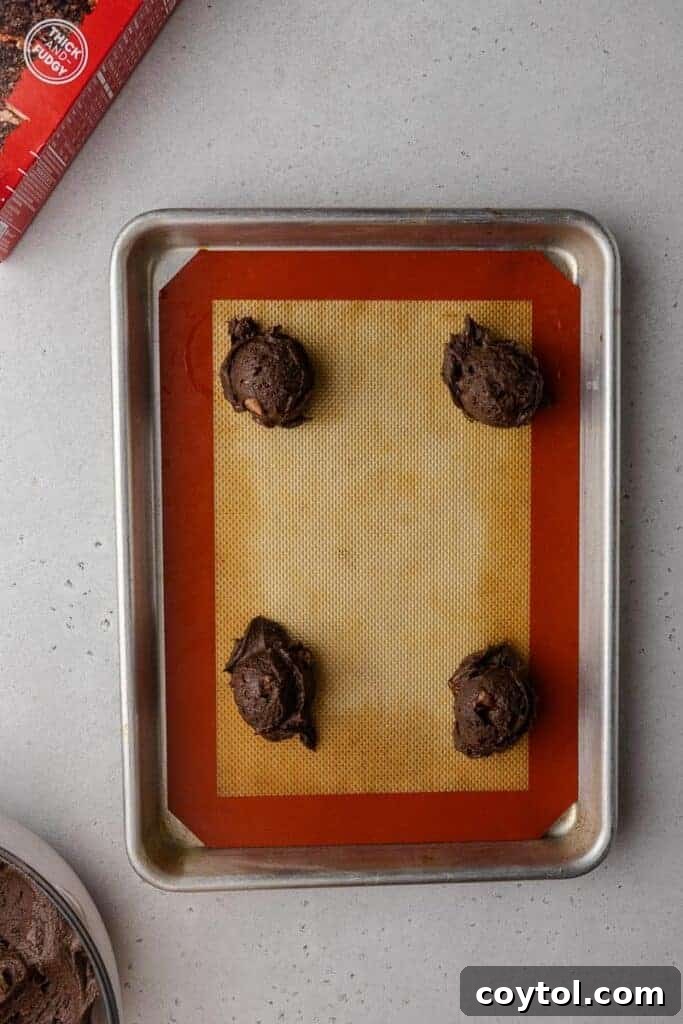 Decadent Crumbl Brownie Batter Cookies 11 Brownie batter cookies arranged on a baking sheet before baking.