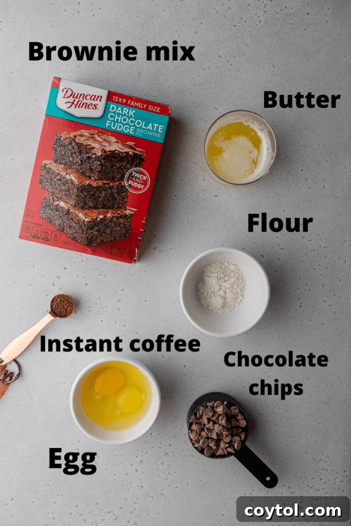 Decadent Crumbl Brownie Batter Cookies 4 Ingredients for brownie mix cookies laid out on a counter: brownie mix, flour, eggs, butter, instant coffee, chocolate chips.