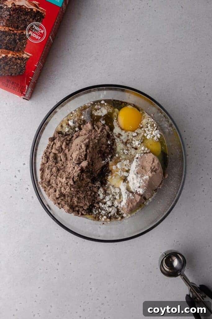 Decadent Crumbl Brownie Batter Cookies 6 Dry and wet ingredients combined in a bowl, ready for mixing.