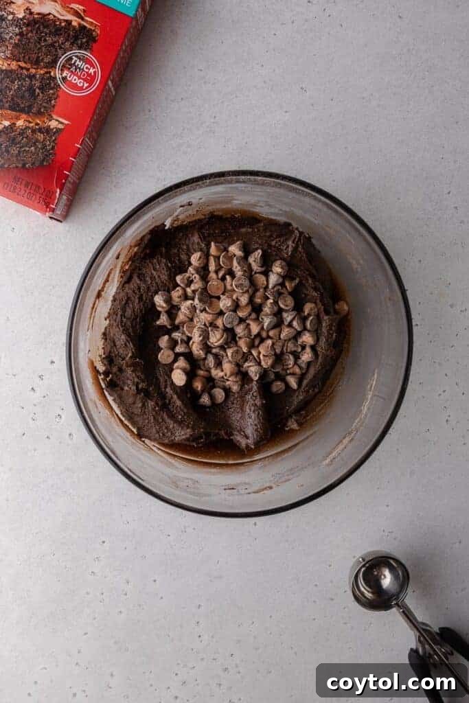 Decadent Crumbl Brownie Batter Cookies 9 Brownie batter cookie dough with chocolate chips.