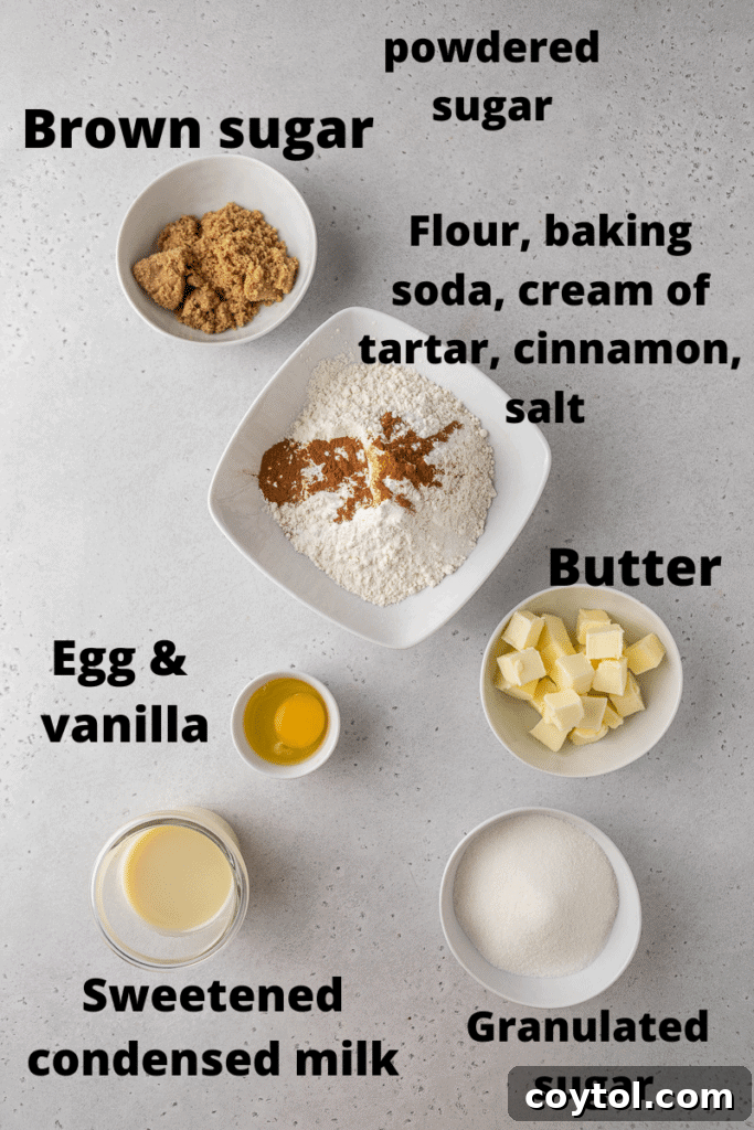 Golden Frosted Cinnamon Fry Bread Cookies 3 A curated selection of fresh ingredients for baking Crumbl Cinnamon Fry Bread cookies, including butter, sugars, eggs, flour, and cinnamon.