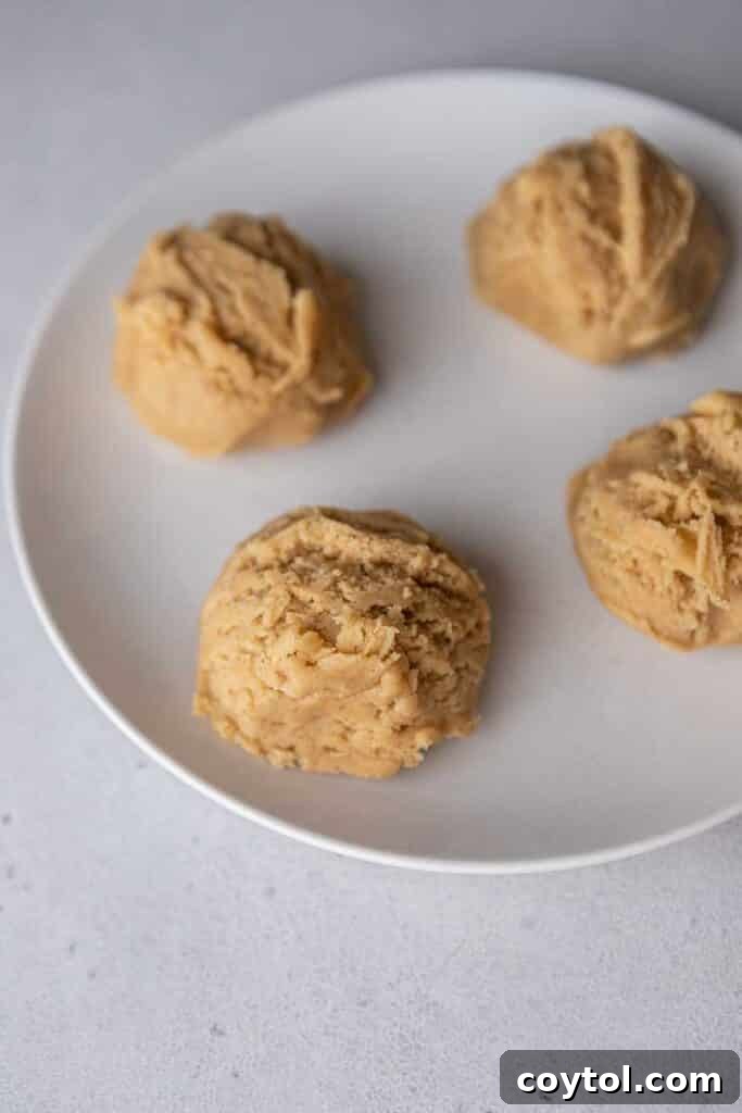 Golden Frosted Cinnamon Fry Bread Cookies 7 Step-by-step: Cookie dough balls shaped and arranged on a baking sheet, pressed slightly flat.