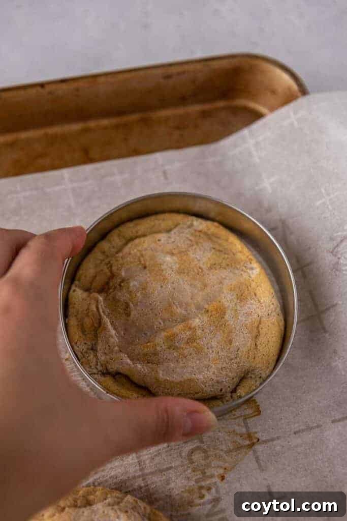 Golden Frosted Cinnamon Fry Bread Cookies 9 Step-by-step: Freshly baked Crumbl Cinnamon Fry Bread cookies cooling on a baking sheet.