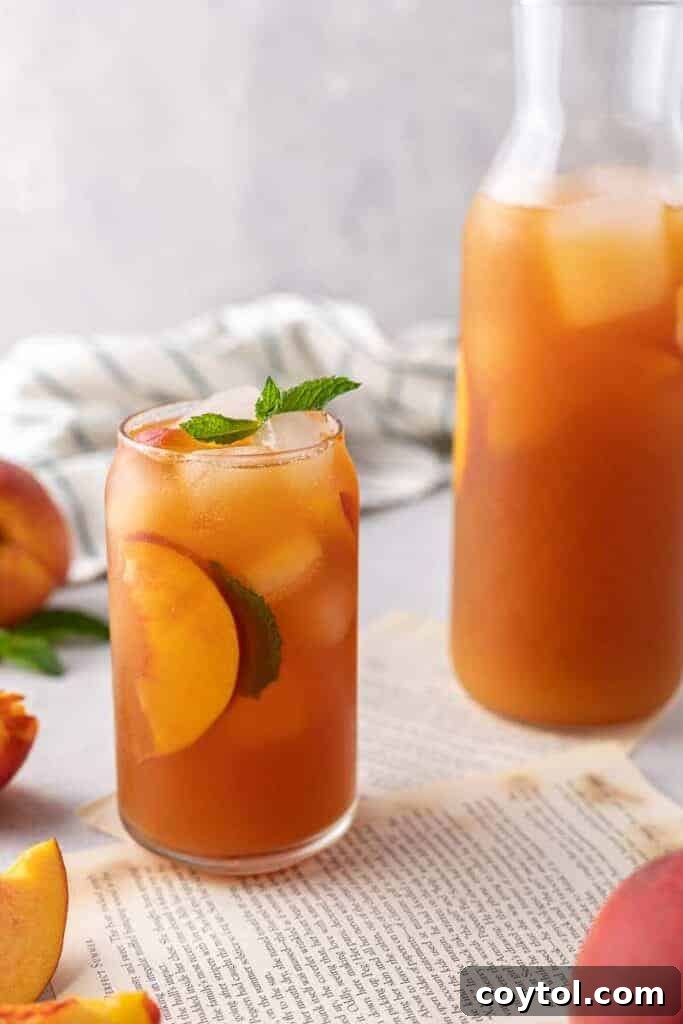 Ice cold peach tea next to pitcher