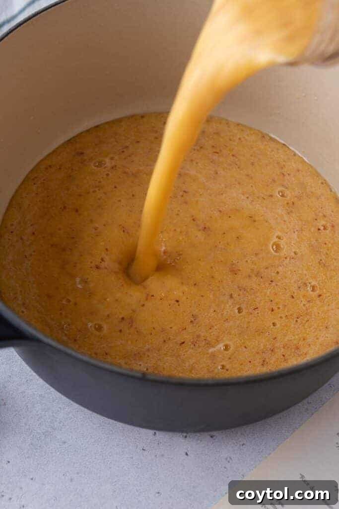 Pouring peach puree in a pot