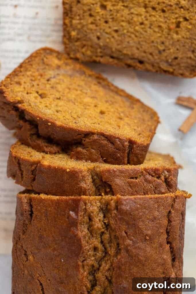Close-up of a perfectly sliced spiced banana bread, showing its moist texture, ready to be served.