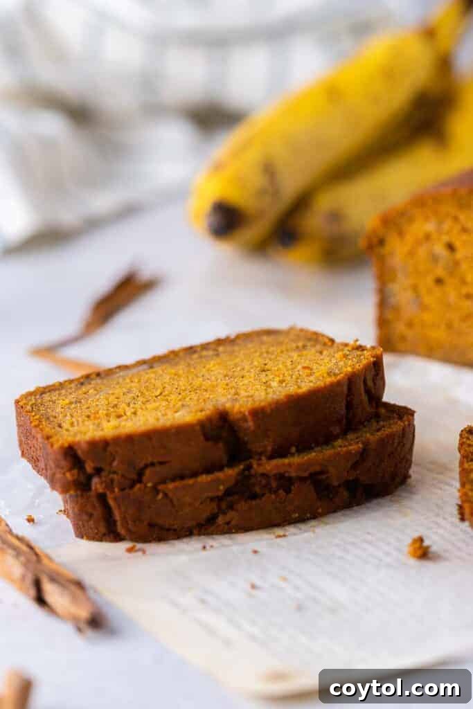 Slices of moist pumpkin banana bread, beautifully stacked, revealing its tender crumb and inviting texture.