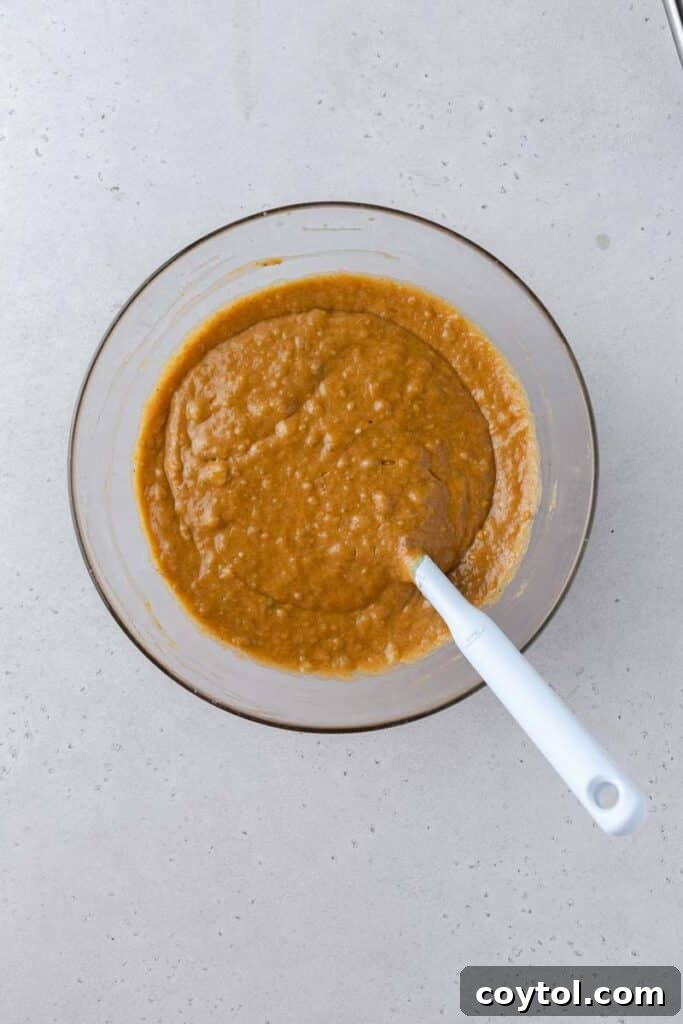 Smooth, well-combined pumpkin banana bread batter in a mixing bowl, ready to be poured into the pan.