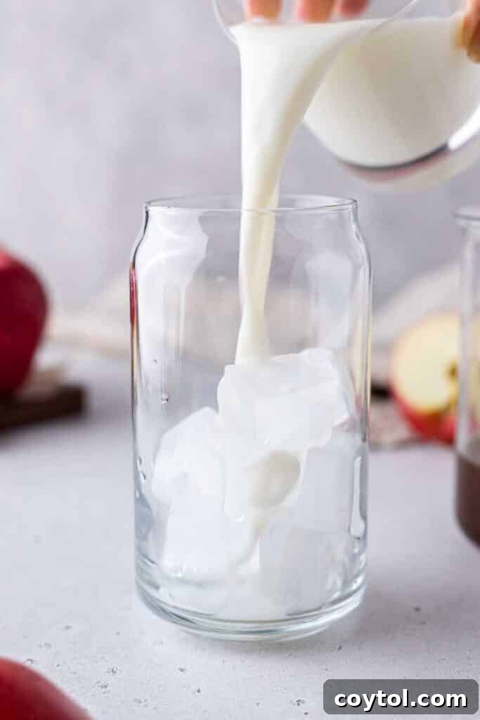 Starbucks Apple Crisp Macchiato Golden Warmth or Chilled Delight 13 Pouring milk in a glass