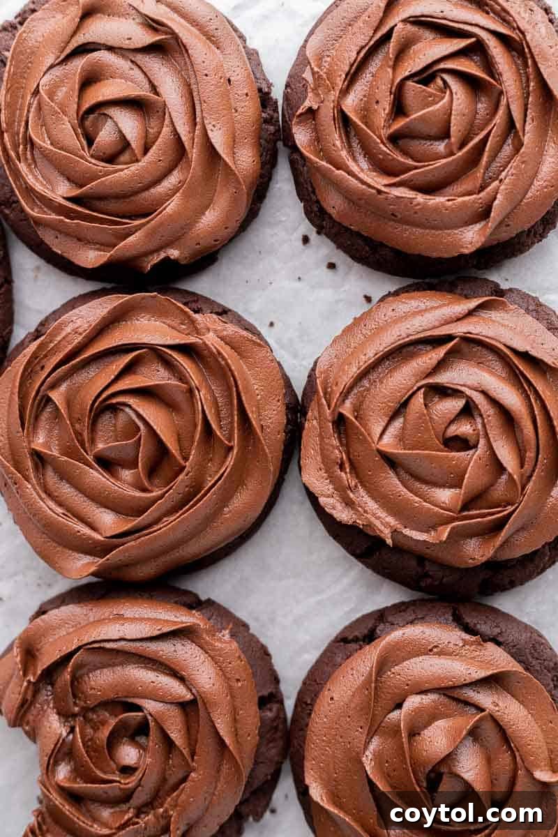 Decadent Crumbl-style chocolate cake cookies, topped with rich, silky chocolate buttercream frosting.