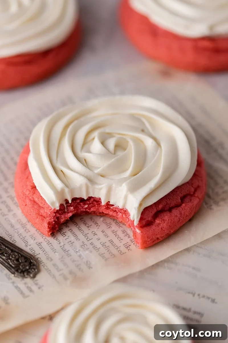 Elegant Crumbl-style Pink Velvet Cookies, soft sugar cookies topped with silky cream cheese frosting.