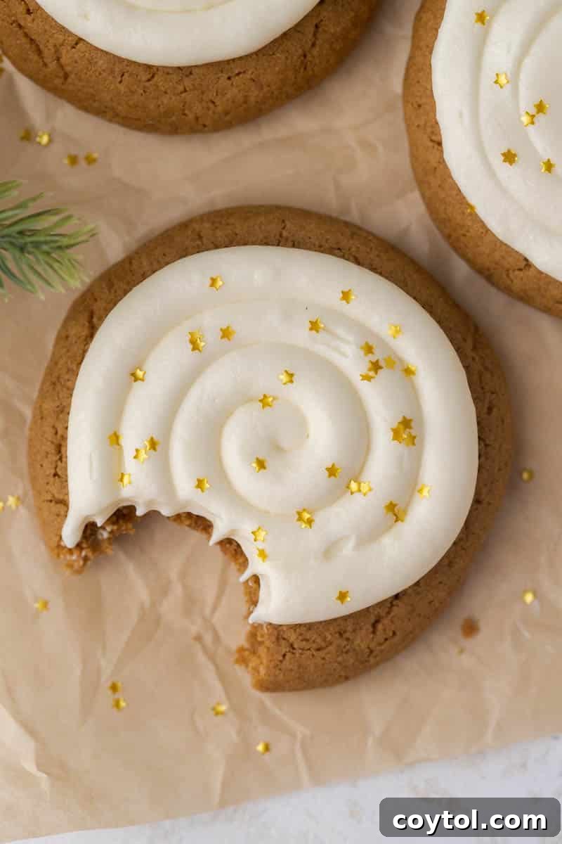 An overhead shot of the best Crumbl-style gingerbread cookies, soft, chewy, and topped with creamy cream cheese frosting.