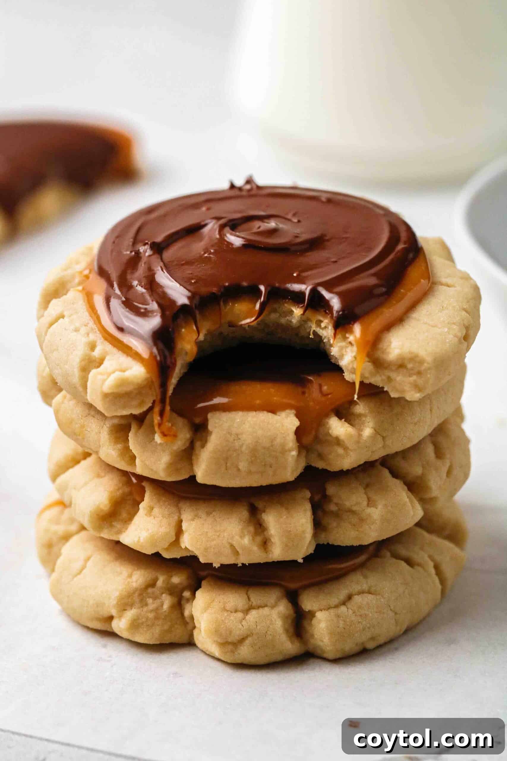 Chilled Crumbl-style Twix cookies, layered with caramel and smooth melted chocolate.