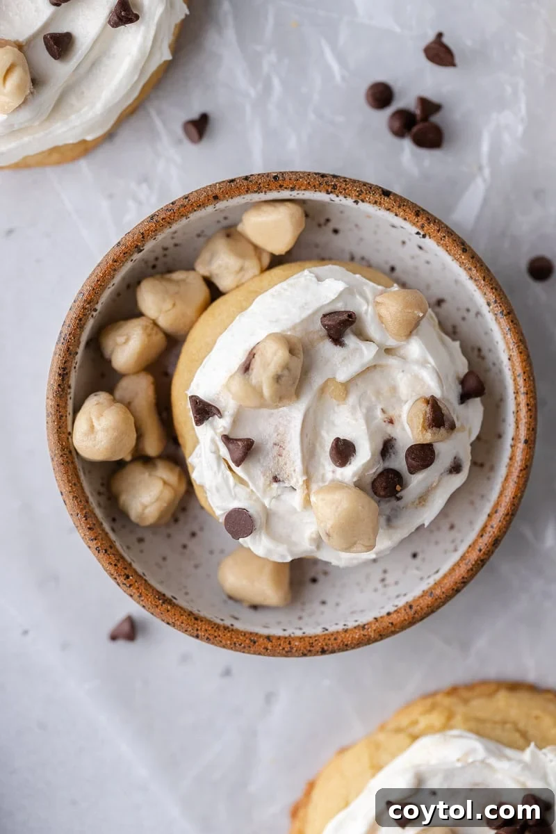 A chilled Crumbl-style Cookie Dough Ice Cream Cookie, topped with caramel frosting and edible cookie dough bites.