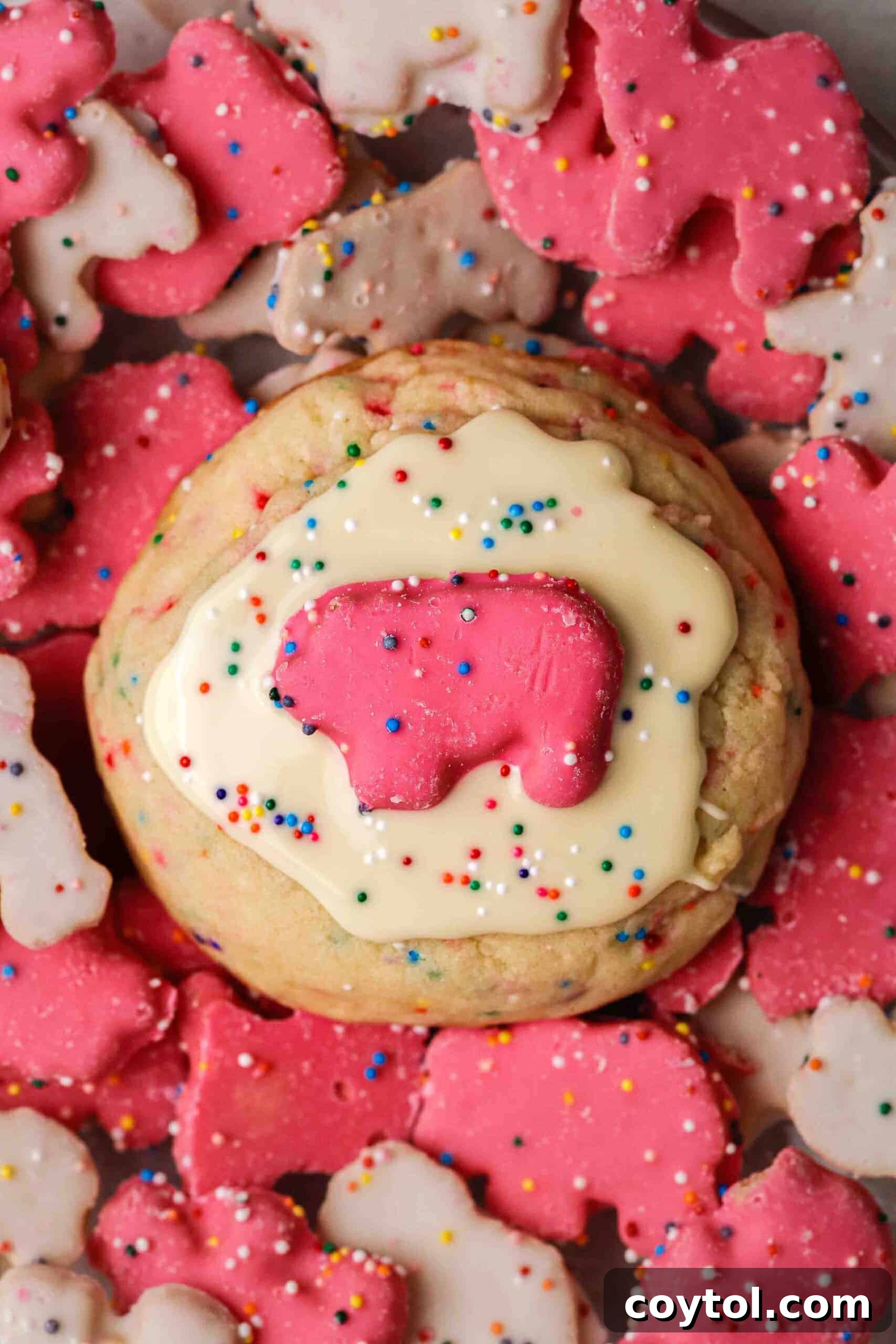 The softest Crumbl-style Circus Animal Cookies, sprinkle-packed sugar cookies with white chocolate glaze and circus animal cookies on top.