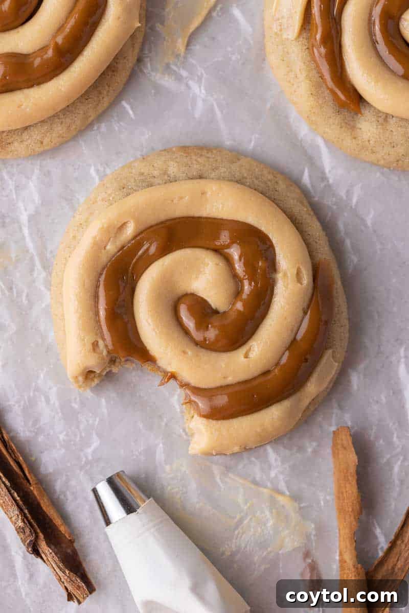 Rich Crumbl-style Dulce de Leche Cookies, cinnamon-spiced and topped with creamy dulce de leche frosting.
